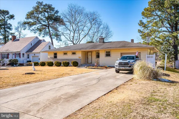 a view of a house with a yard covered in snow