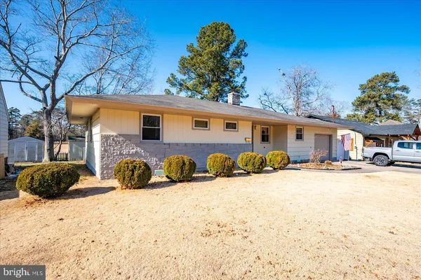 a view of a house with snow on the road