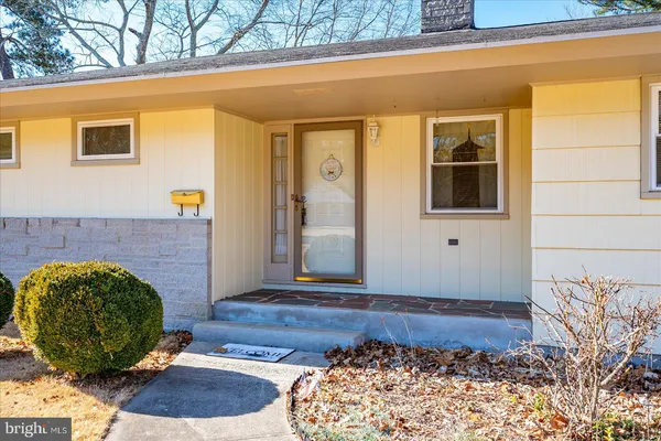 a view of a hallway with wooden floor and windows