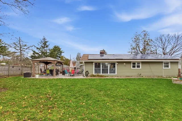 a front view of a house with a garden and yard