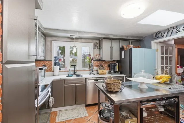a kitchen with a sink appliances and cabinets
