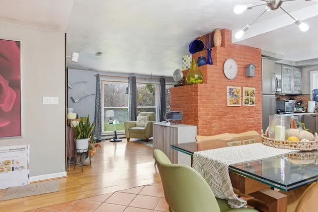 a living room with fireplace furniture and a large window