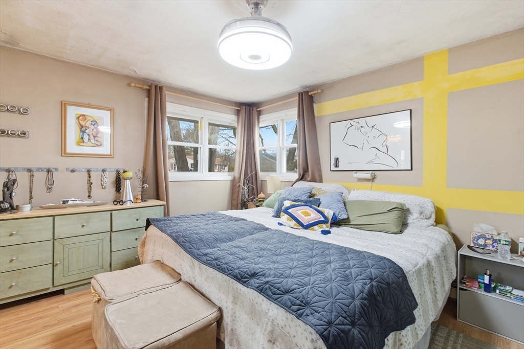 35 Errol Road Brockton, MA 02302 - Photo 9 of 20 a bedroom with a bed and a chandelier