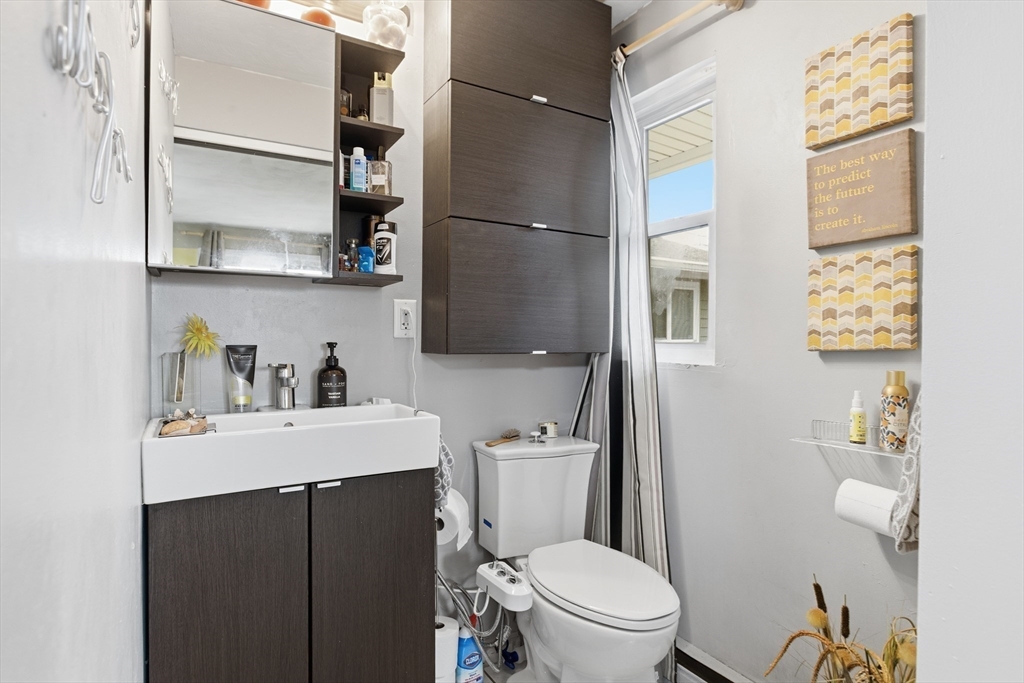 35 Errol Road Brockton, MA 02302 - Photo 10 of 20 a bathroom with a sink a toilet and a shower curtain