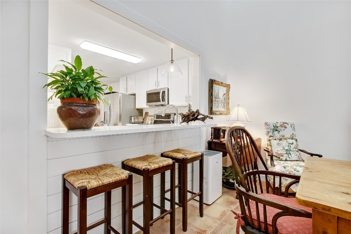 3426 Sea Marsh Road Fernandina Beach, FL 32034 - Photo 14 of 65 a kitchen with granite countertop white cabinets and chairs