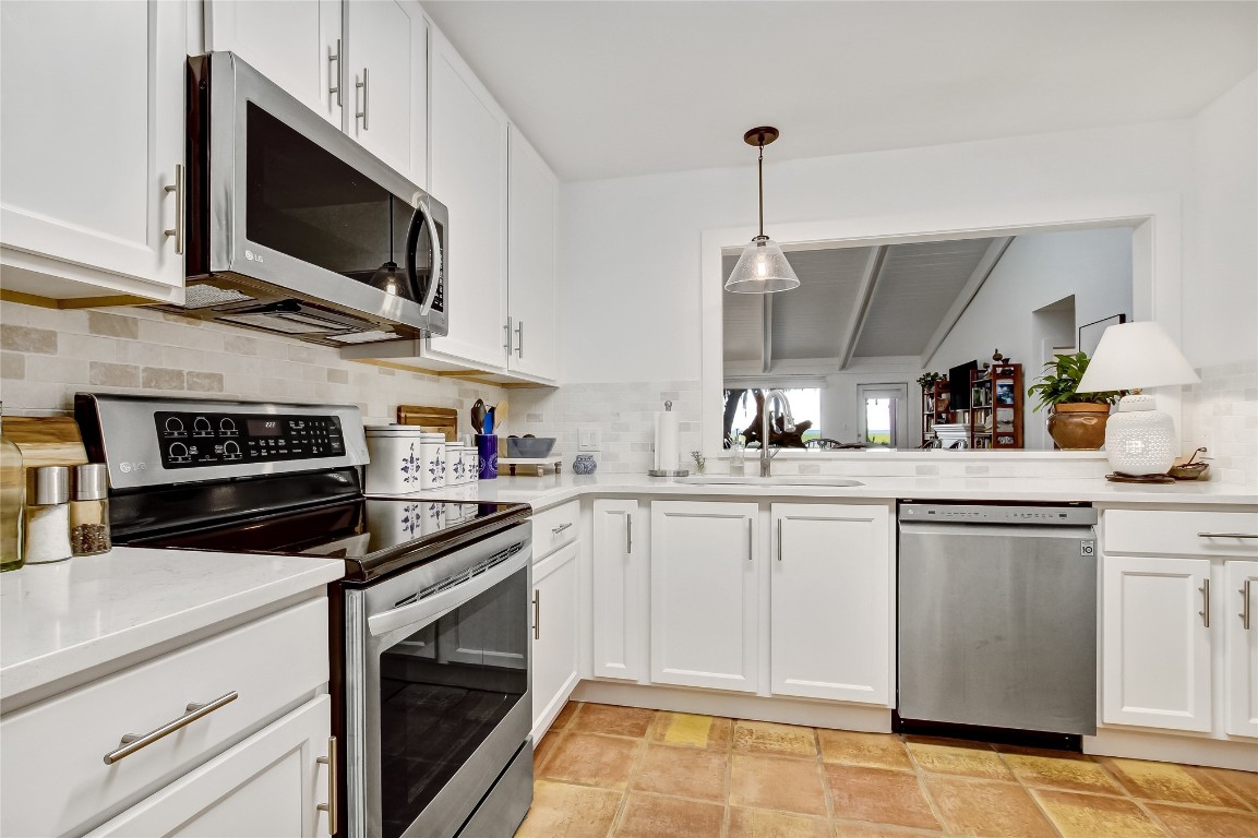 3426 Sea Marsh Road Fernandina Beach, FL 32034 - Photo 6 of 65 a kitchen with cabinets stainless steel appliances and a counter space
