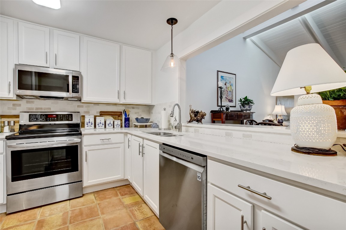 3426 Sea Marsh Road Fernandina Beach, FL 32034 - Photo 7 of 65 a kitchen with granite countertop a sink and stainless steel appliances