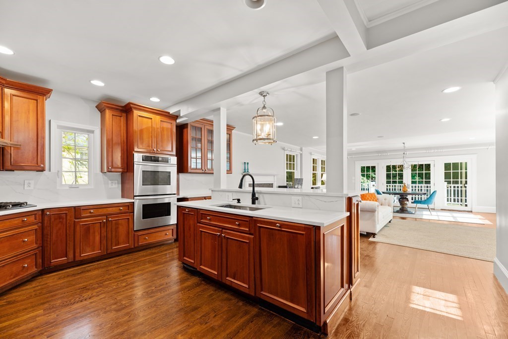 28 Hillside Road Wellesley, MA 02481 - Photo 5 of 25 a large kitchen with kitchen island granite countertop a large window a sink and stainless steel appliances