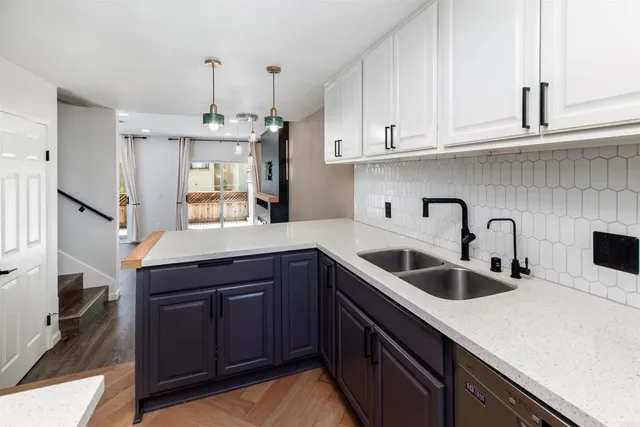 a kitchen with stainless steel appliances granite countertop a sink a stove and a refrigerator