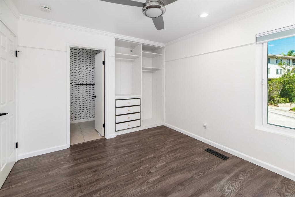 2349 Altisma Way, Unit B Carlsbad, CA 92009 - Photo 13 of 25 an empty room with wooden floor and windows