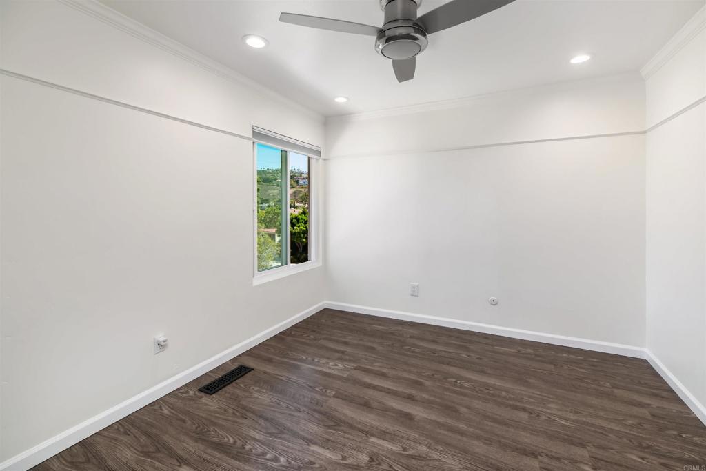 2349 Altisma Way, Unit B Carlsbad, CA 92009 - Photo 14 of 27 an empty room with a window and a ceiling fan