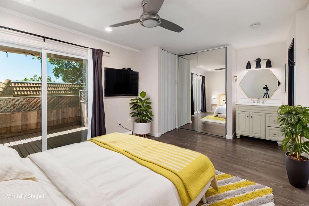 2349 Altisma Way, Unit B Carlsbad, CA 92009 - Photo 17 of 25 a spacious bedroom with a large bed and a potted plant