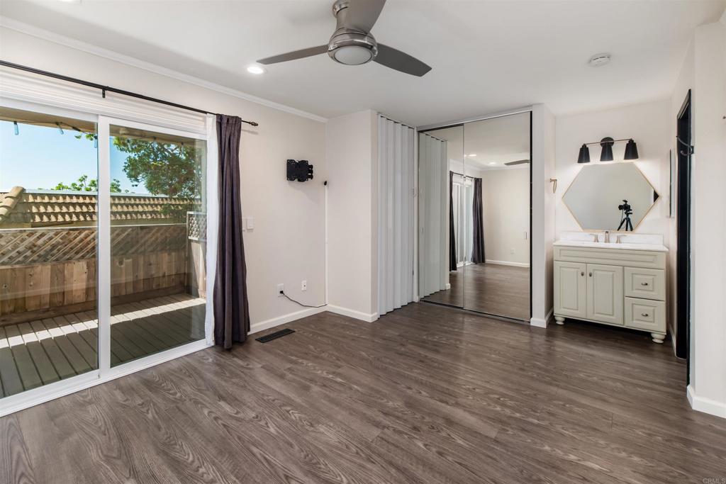 2349 Altisma Way, Unit B Carlsbad, CA 92009 - Photo 18 of 27 a view of an empty room with a window and wooden floor