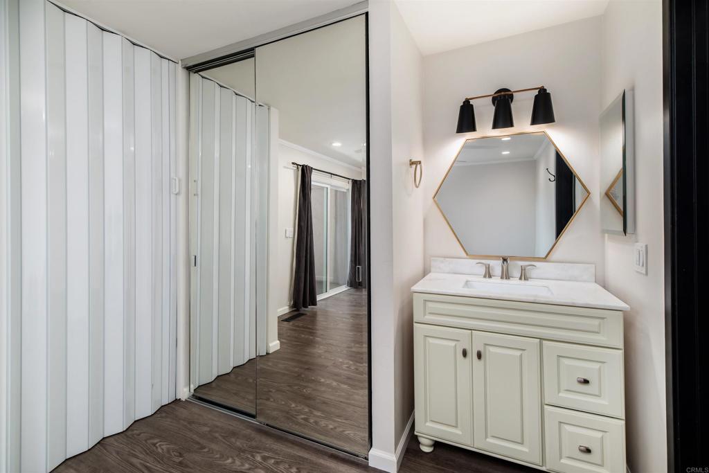2349 Altisma Way, Unit B Carlsbad, CA 92009 - Photo 19 of 25 a bathroom with a sink vanity toilet and a mirror