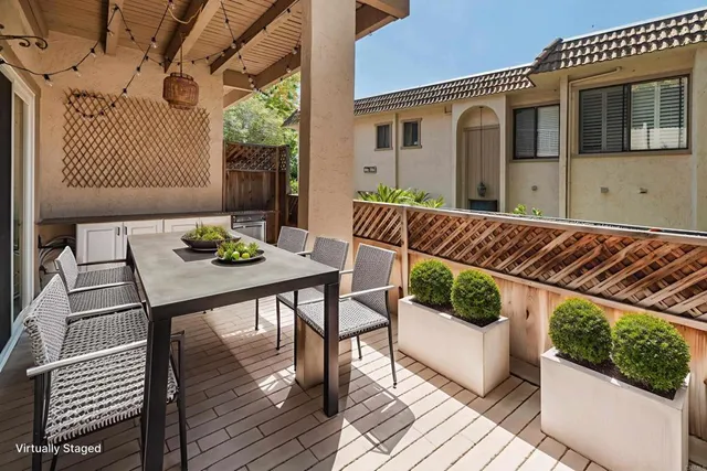 a view of balcony with furniture and wooden floor
