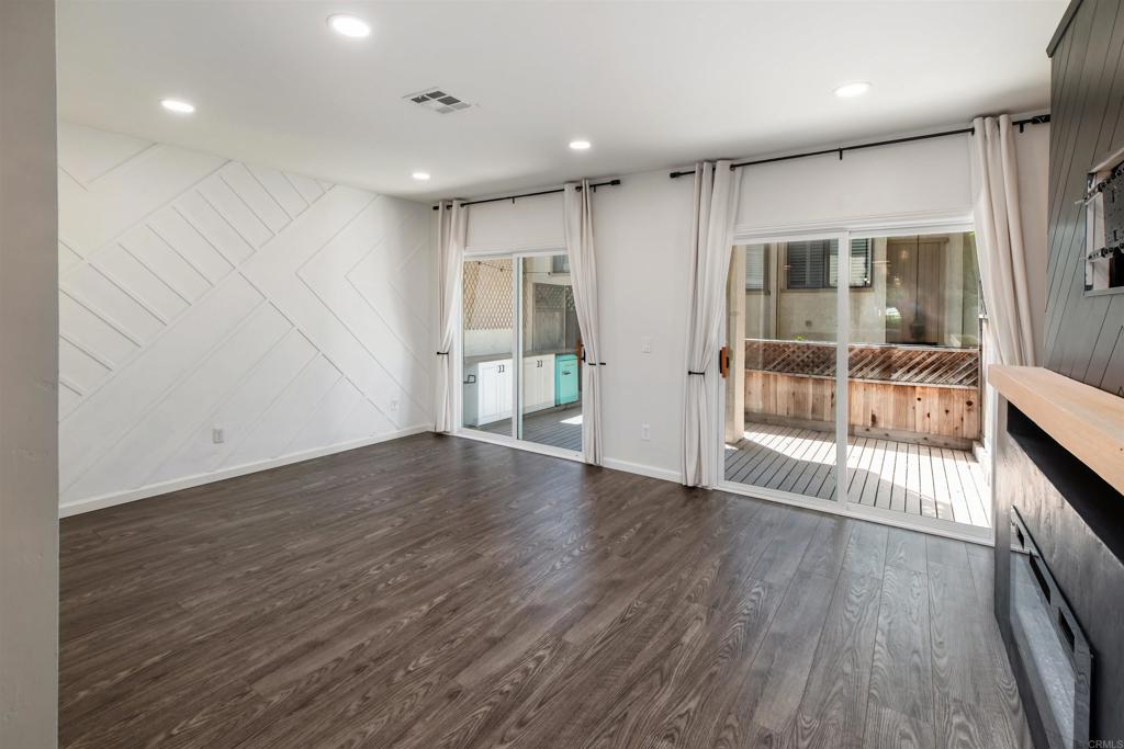 2349 Altisma Way, Unit B Carlsbad, CA 92009 - Photo 10 of 25 an empty room with wooden floor and windows
