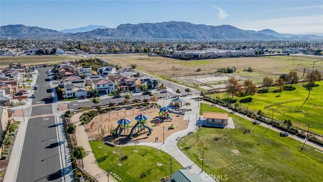 a swimming pool with outdoor seating and a garden