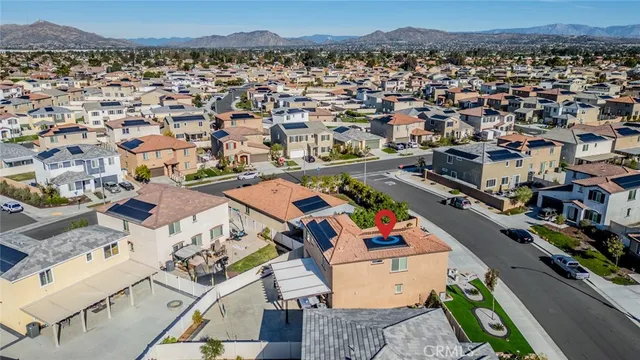 an aerial view of a houses with a swimming pool