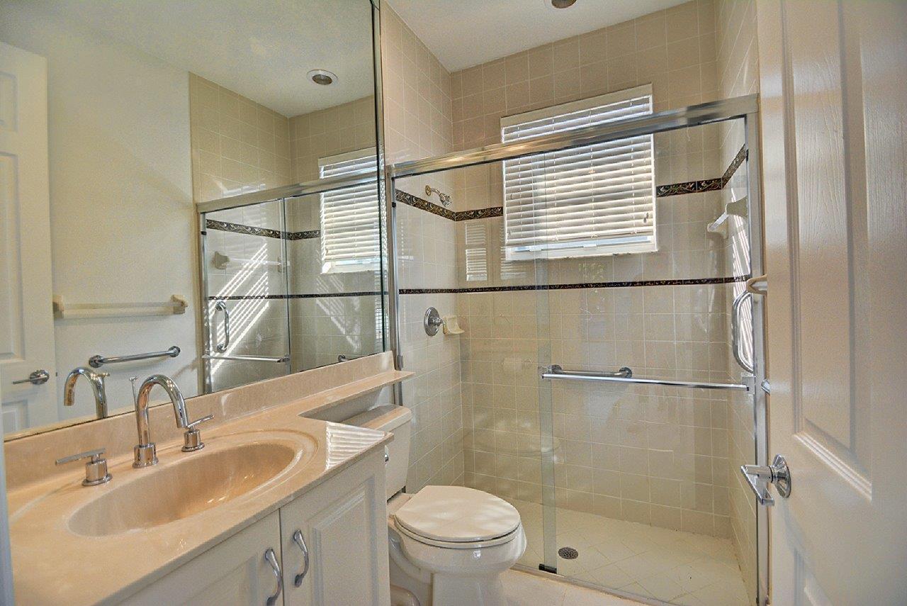 19473 Saturnia Lakes Drive Boca Raton, FL 33498 - Photo 17 of 22 a bathroom with a sink toilet and shower
