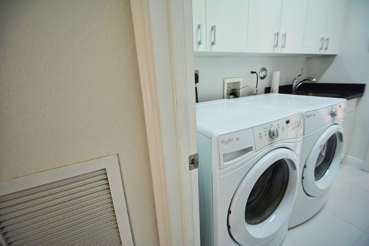 19473 Saturnia Lakes Drive Boca Raton, FL 33498 - Photo 18 of 22 a view of storage and utility room with washer and dryer
