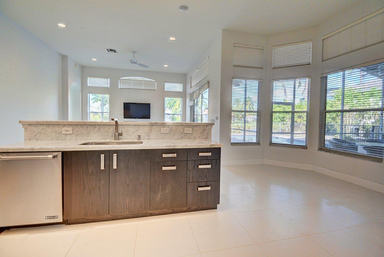 19473 Saturnia Lakes Drive Boca Raton, FL 33498 - Photo 3 of 22 a bathroom with a granite countertop sink and a large mirror