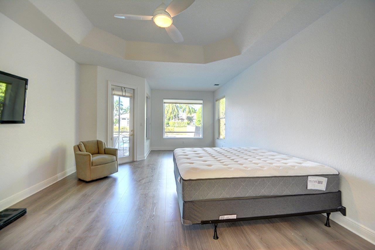 19473 Saturnia Lakes Drive Boca Raton, FL 33498 - Photo 10 of 22 a bedroom with a bed and a couch