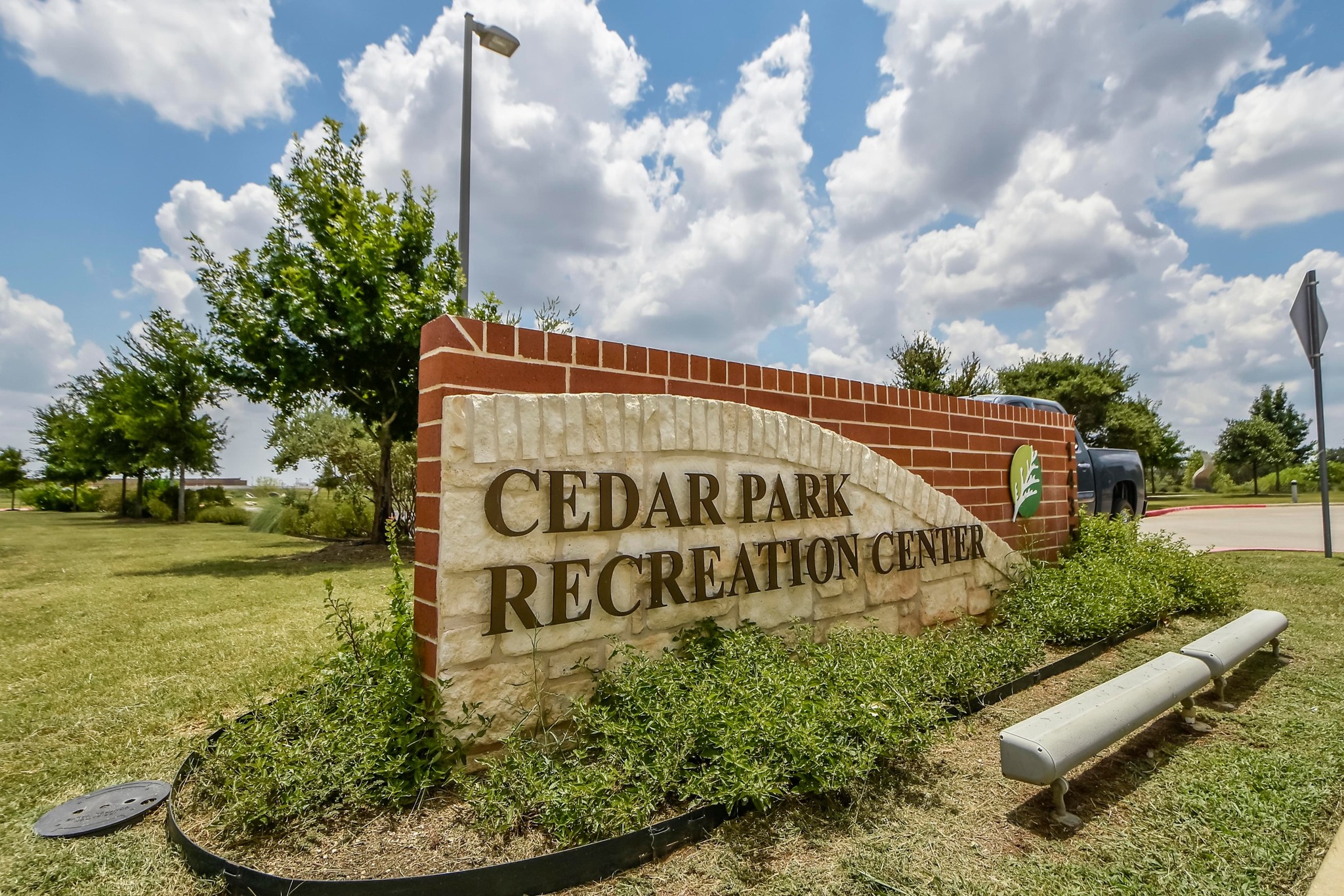 1818 Lost Maples Loop Cedar Park, TX 78613 - Photo 37 of 38 A welcoming stone and brick sign announces the Cedar Park Recreation Center amid verdant landscaping.