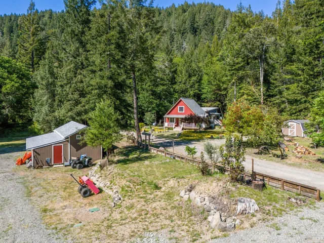 a backyard of a house with table and chairs