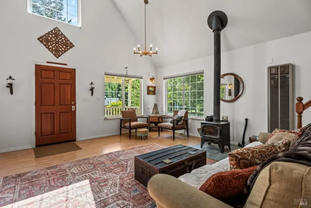 a dining room with furniture a chandelier and wooden floor