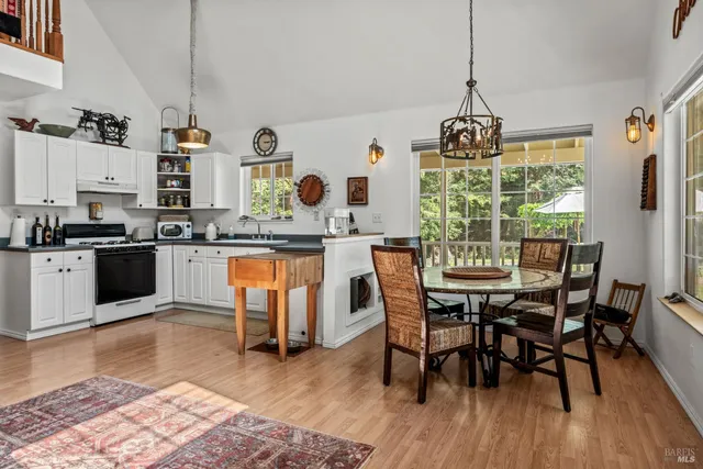 a kitchen with granite countertop a sink cabinets and stainless steel appliances