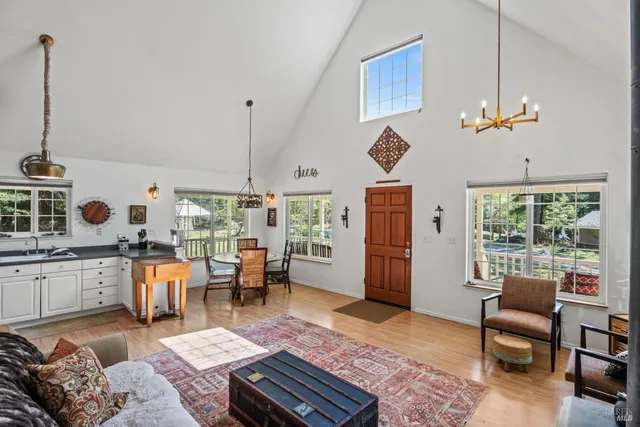 a kitchen with white cabinets and a window