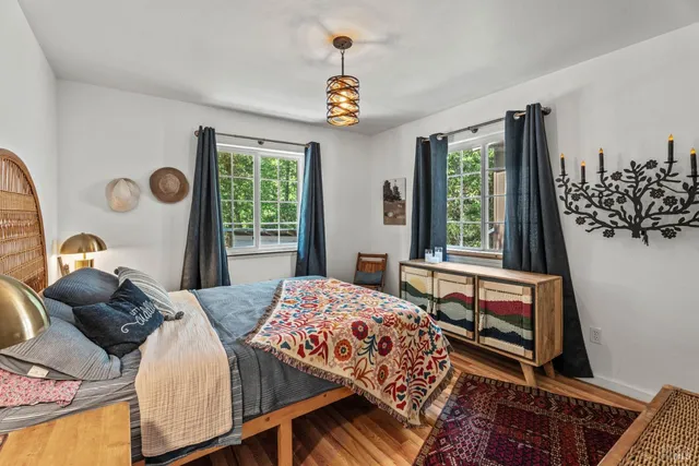 a bedroom with a bed and a dresser with mirror