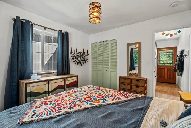 a living room with furniture a rug and a window