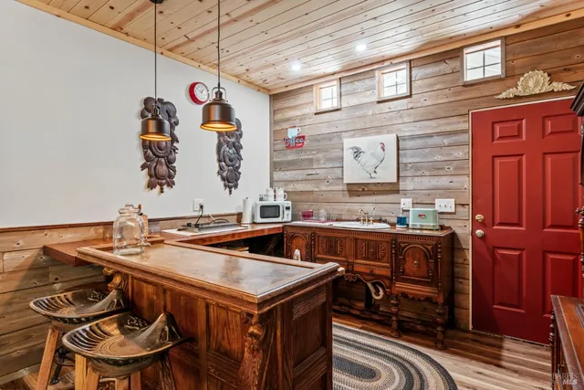 a bathroom with a sink a granite counter and a glass door shower