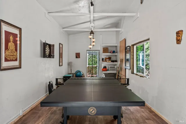 a living room with furniture a window and a flat screen tv