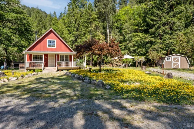 a view of a chair and table with umbrella in the yard