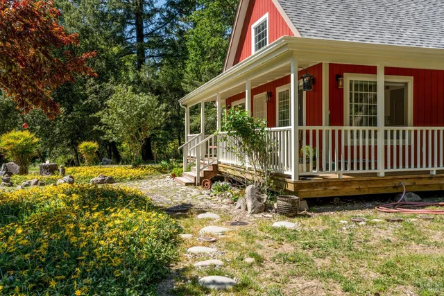 a view of a house with backyard and sitting area