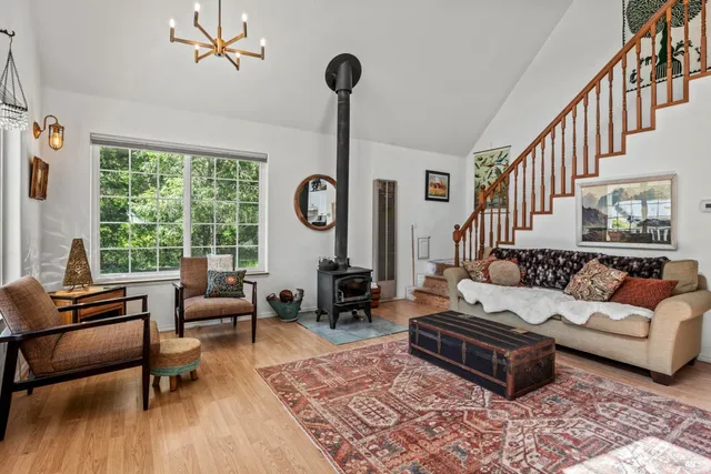 a living room with furniture a window and a chandelier