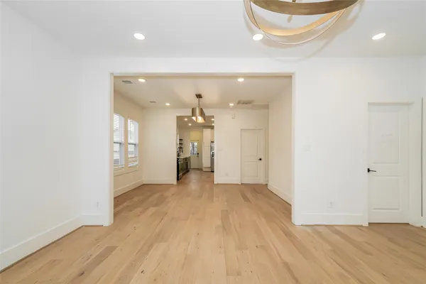 a view of a room with wooden floor and a large window