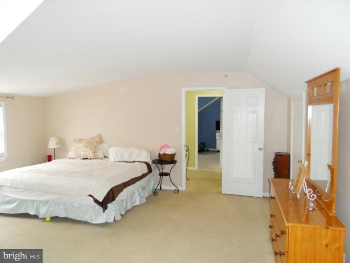 1934 Greengage Road Baltimore, MD 21244 - Photo 7 of 16 a bedroom with a bed and walk in closet