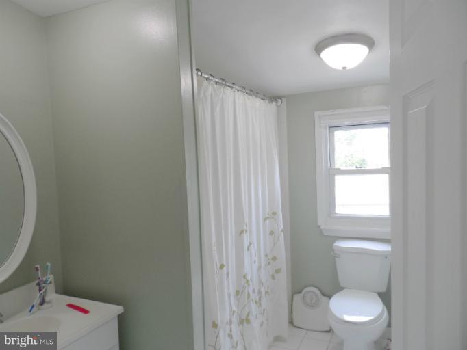 1934 Greengage Road Baltimore, MD 21244 - Photo 8 of 16 a white toilet sitting next to a bathroom sink