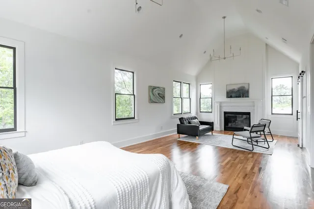 a spacious bedroom with a bed a couch and a fireplace