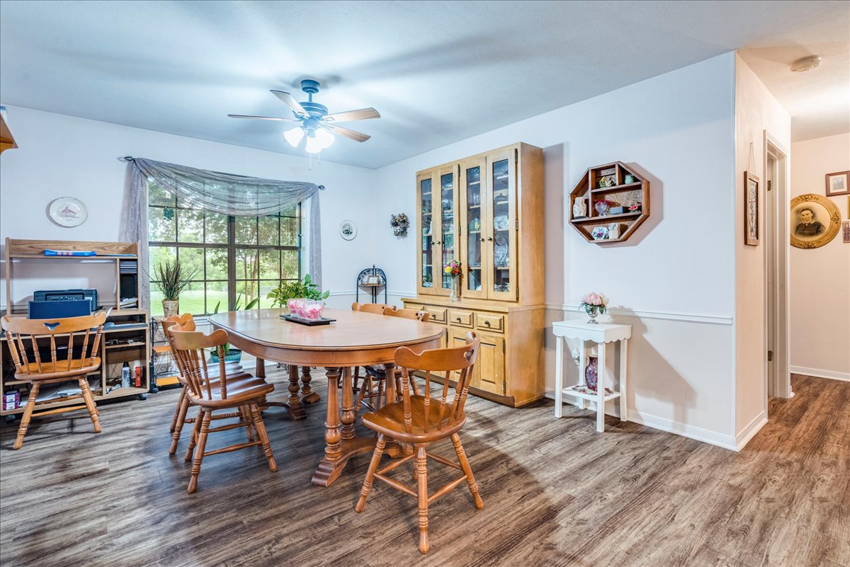 1704 Buttercup Road Pflugerville, TX 78660 - Photo 15 of 37 A welcoming dining area offers ample space for gatherings, illuminated by natural light and a ceiling fan.