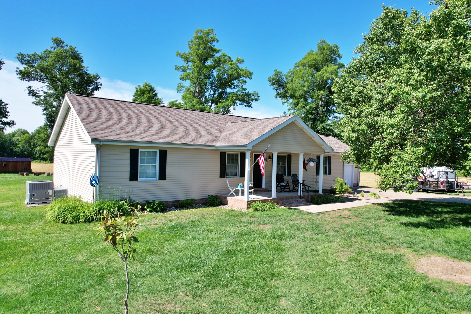 5012 Rosebud Road Metropolis, IL 62960 - Photo 1 of 44 a front view of a house with a yard and sitting area