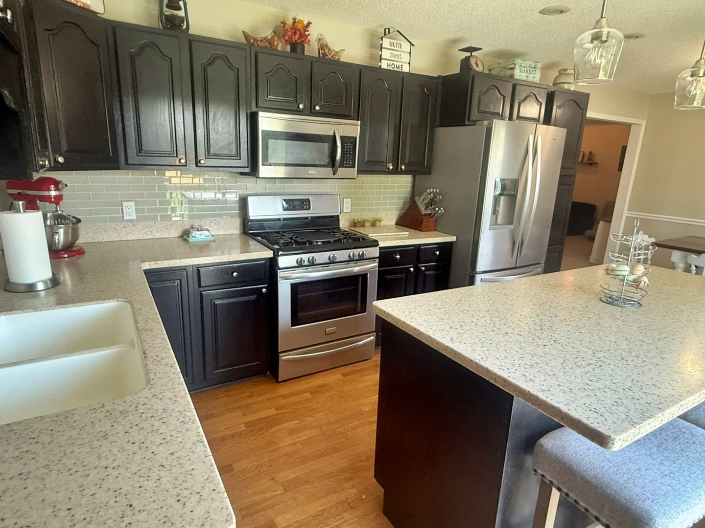5012 Rosebud Road Metropolis, IL 62960 - Photo 26 of 44 a kitchen with stainless steel appliances granite countertop a sink stove microwave and refrigerator