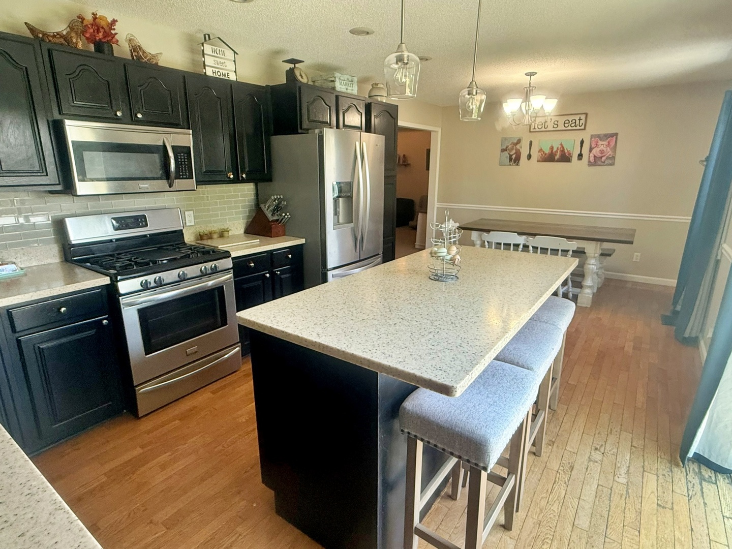 5012 Rosebud Road Metropolis, IL 62960 - Photo 27 of 44 a kitchen with kitchen island a refrigerator stove and microwave