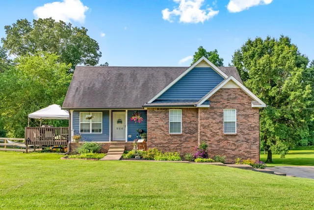 a front view of a house with a garden