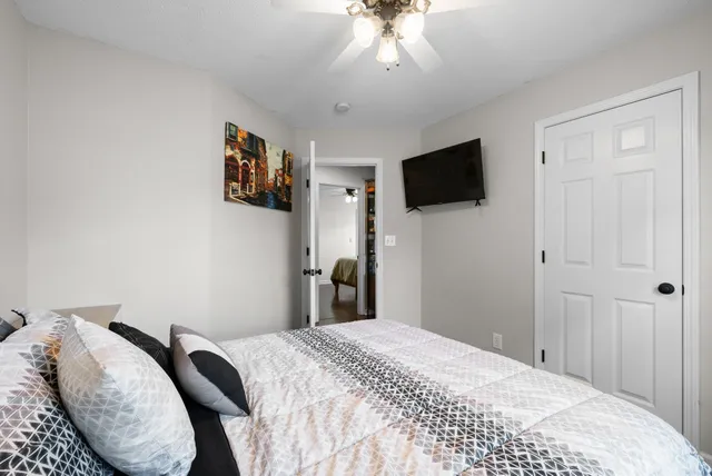 a bedroom with a bed and a flat screen tv