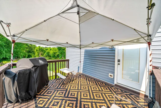 a view of a balcony with wooden floor and outdoor space