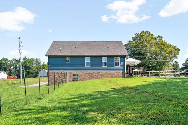 a view of a house with a backyard porch and sitting area